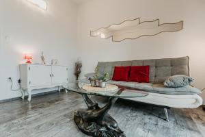 a living room with a couch and a glass table at Apartments Borik Crikvenica in Crikvenica