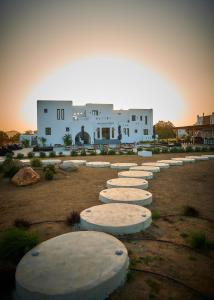 a row of stepping stones in front of a building at Naxian Secret in Naxos Chora