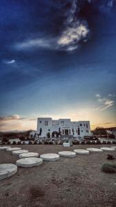 a group of white buildings in a field at Naxian Secret in Naxos Chora