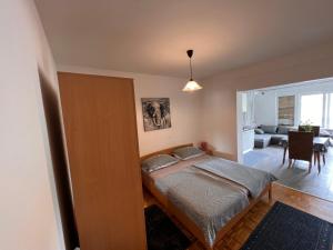 a bedroom with a bed and a living room at Apartmani Premijer-Rab in Supetarska Draga