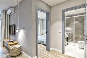 a bedroom with a bathroom with a bed and a mirror at Yacht Park Marina by AmberBlue in Gdynia