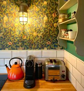 a kitchen counter with a toaster and a toaster and a toaster at Old King William Shepherd Huts and Private Hot Tubs in North Norfolk in Hunworth