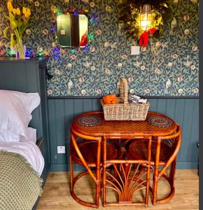 a table with a basket on it in a bedroom at Old King William Shepherd Huts and Private Hot Tubs in North Norfolk in Hunworth