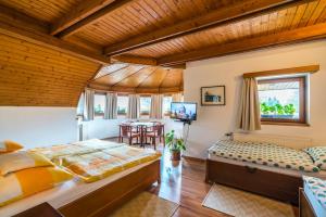 a bedroom with a bed and a table at Szent Kristóf Panzió in Esztergom