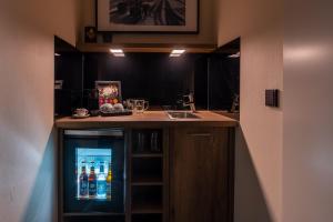 a small kitchen with a counter with a refrigerator at LIHO - einfach Lübeck in Lübeck