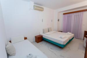 Postel nebo postele na pokoji v ubytování Hotel Philoxenia