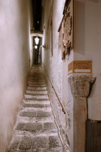 an alleyway in an old building with stone stairs at Amalfi Suite Boutique Hotel in Amalfi