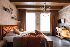 a bedroom with a bed and a chair and a window at B&B Slapen bij DKW in Oldebroek