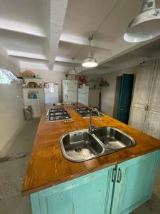 a kitchen with a sink and a counter top at Qiwi House in Ureki