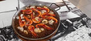 a pan filled with shrimp on top of a stove at Hostal Vila del Mar in Lloret de Mar