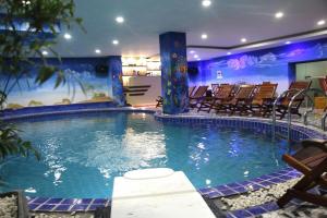 a large swimming pool with chairs in a hotel at Vientiane Luxury Hotel in Vientiane