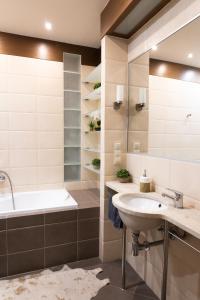 a bathroom with a sink and a bath tub and a shower at ClickTheFlat Szkolna Palace of Culture Apart Rooms in Warsaw