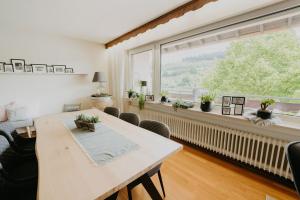 a living room with a table and a large window at Ferienhaus Anni in Zell an der Mosel