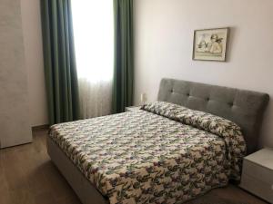 a bedroom with a bed with a quilt on it at Case Pagano Mare in Taormina