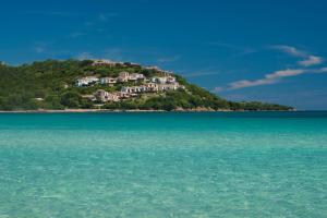 a house on an island in the water at Hotel Palumbalza Porto Rotondo in Porto Rotondo