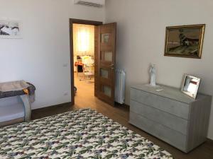 a bedroom with a bed and a dresser and a door at Case Pagano Mare in Taormina