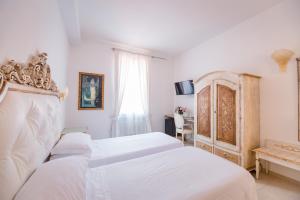 a bedroom with a bed and a dresser at Residenza Due Torri check in presso HOTEL CENTRALE Vicolo Cattani 7 in Bologna