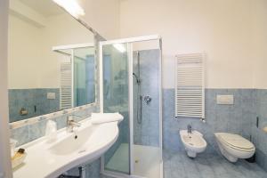 a bathroom with a toilet a sink and a shower at Residenza Due Torri check in presso HOTEL CENTRALE Vicolo Cattani 7 in Bologna