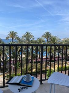 a view from a balcony with a table and a cup at Casual Pop Art Benidorm in Benidorm