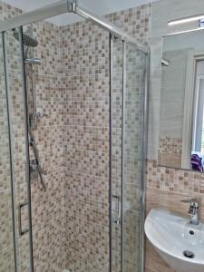 a bathroom with a glass shower and a sink at Casa Sofia in Gaeta