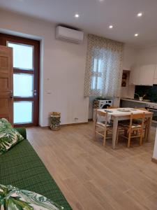 a kitchen and dining room with a table and chairs at Case Pagano Mare in Taormina