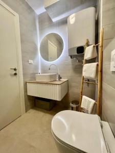 a bathroom with a white sink and a mirror at Apartmani CUBE A in Medulin +36 photos