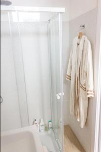 a bathroom with a shower with a glass door at [DOWNTOWN SELINUS] Bright apartment with courtyard in Marinella di Selinunte