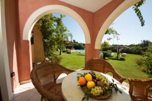 a bowl of fruit on a table on a patio at Hotel Mariposas in Villasimius