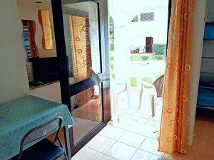 a room with a table and a glass door with a table and chairs at Aldeia das Açoteias, Apartment, WI-FI, in Albufeira