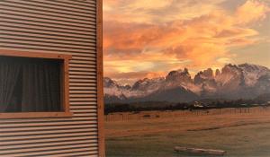 a window of a house with a view of mountains at Vista al Paine - Refugio de Aventura in Torres del Paine