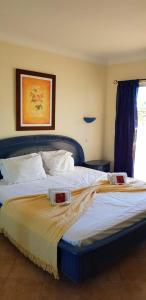 a bedroom with a bed with two plates on it at Praia Oura Sunset in Albufeira