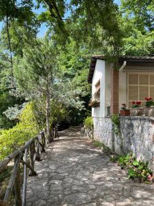 a stone path leading to a house with a fence at Casetta Lake and Sun in Labro