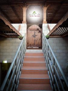 a staircase leading up to a wooden door with a wooden gate at Mali Country Hospitality in Eilat