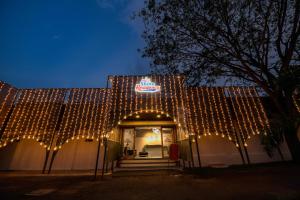 un edificio cubierto de luces con una señal en él en Shine Residency en Mysore