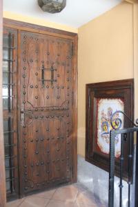 a large wooden door in the corner of a room at Hostal Maria Ronda in Madrid