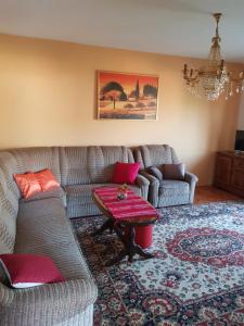 a living room with two couches and a table at Apartman Petar in Trebinje