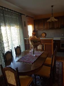 a table in a kitchen with a table and chairs at Apartman Petar in Trebinje