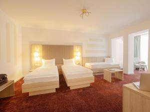 Een bed of bedden in een kamer bij Hotel Brenner