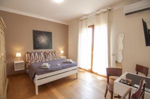 a bedroom with a bed and a table and chairs at B&B Antico Sentiero in Cesena