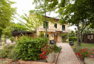 a house with flowers in front of it at B&B Antico Sentiero in Cesena