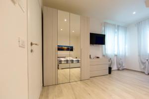 a bedroom with a sliding door with a bed in it at Aria di Mare in Martinsicuro