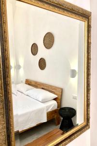 a mirror reflection of a bed in a bedroom at Dimora delle Tonnare in Favignana