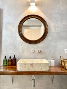a bathroom with a marble sink and a mirror at Dimora delle Tonnare in Favignana