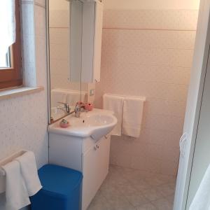 a white bathroom with a sink and a mirror at Baita Bocheto Vetriolo Levico Terme in Vetriola