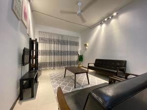 a living room with a couch and a table at Medina Homestay Chukai Kemaman in Cukai