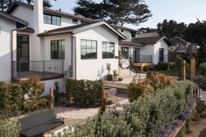 a white house with a garden in front of it at Villa Mara Carmel in Carmel +30 photos