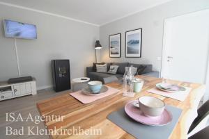 a living room with a table with plates and bowls on it at RMG Roses Apartments in Bad Kleinkirchheim