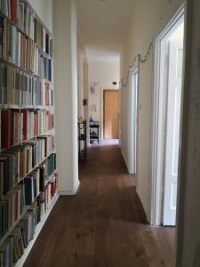 a hallway with bookshelves filled with books at Camera vintage nel cuore di Monteverde in Rome