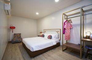 a bedroom with a white bed and a mirror at Sweet's Escape in Bangkok