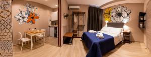 a hotel room with a bed and a table and a kitchen at ASTARE -short lets in bari carrassi- in Bari